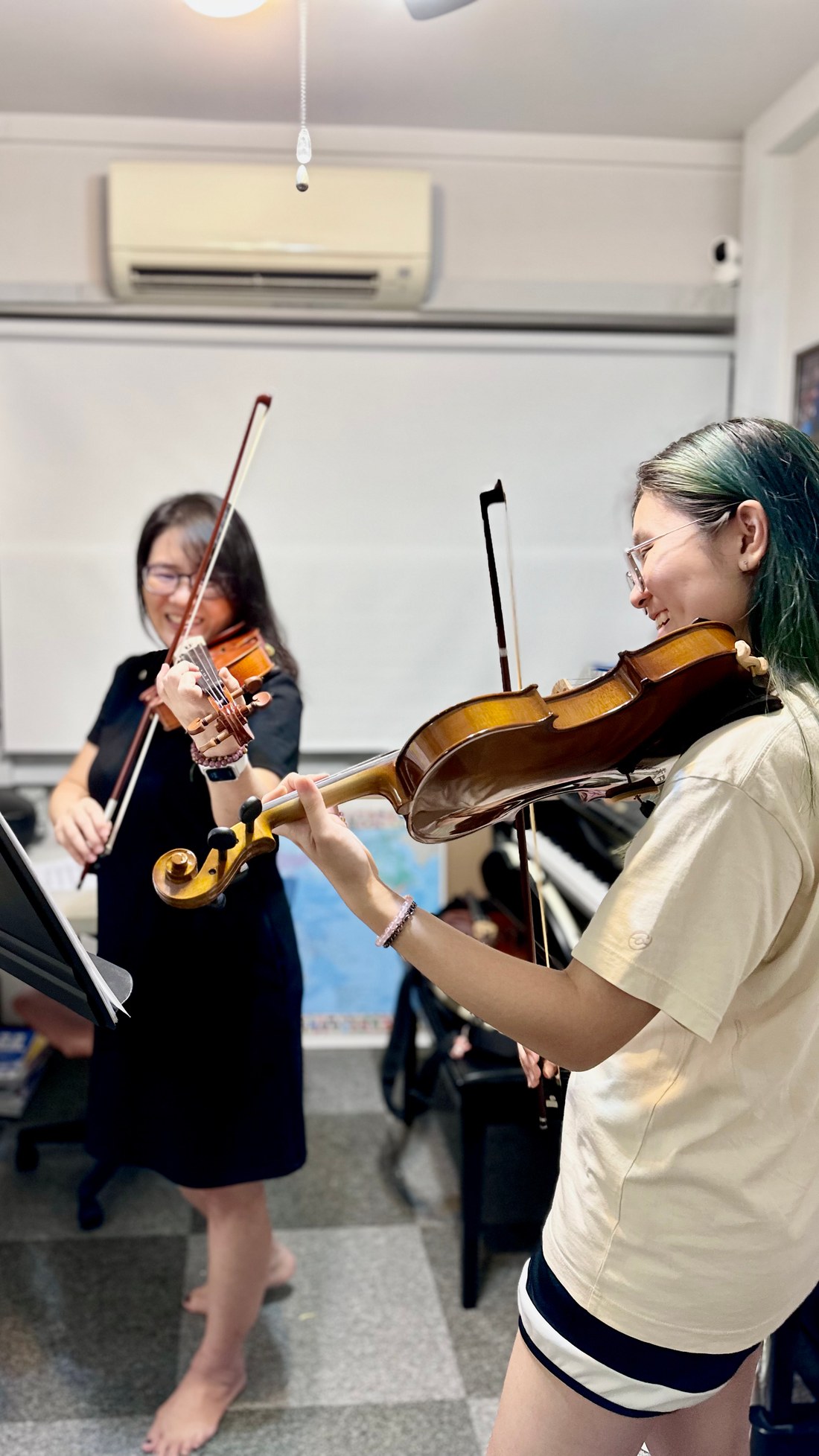 Students playing violin together in a group class